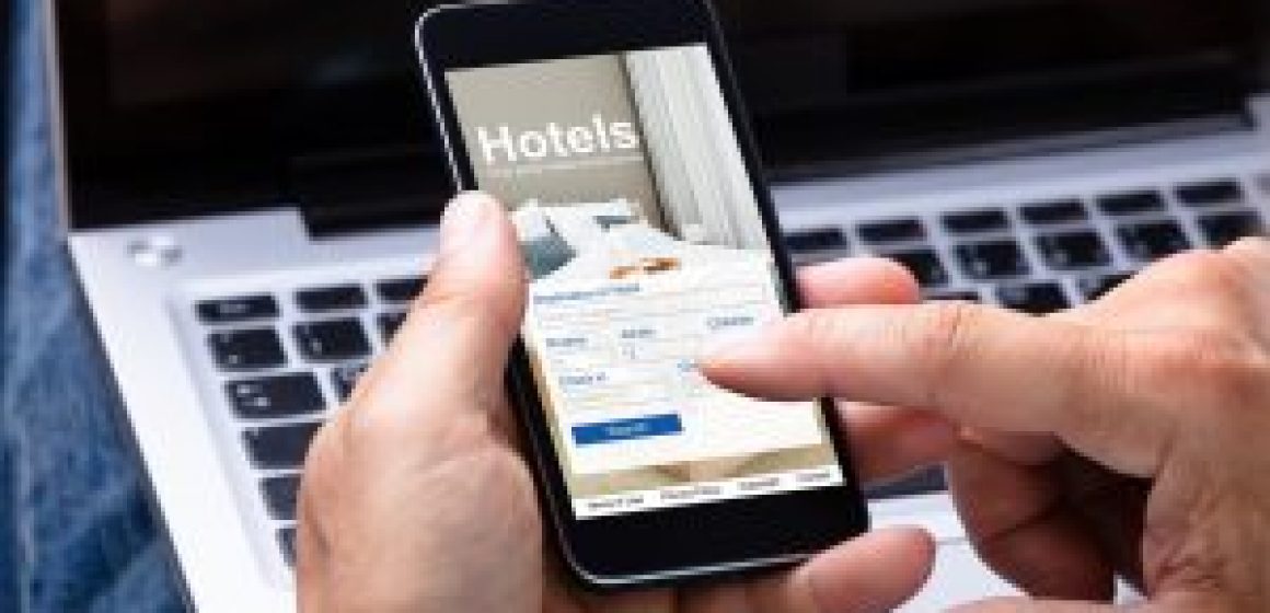 Man Booking Hotel Using Smartphone